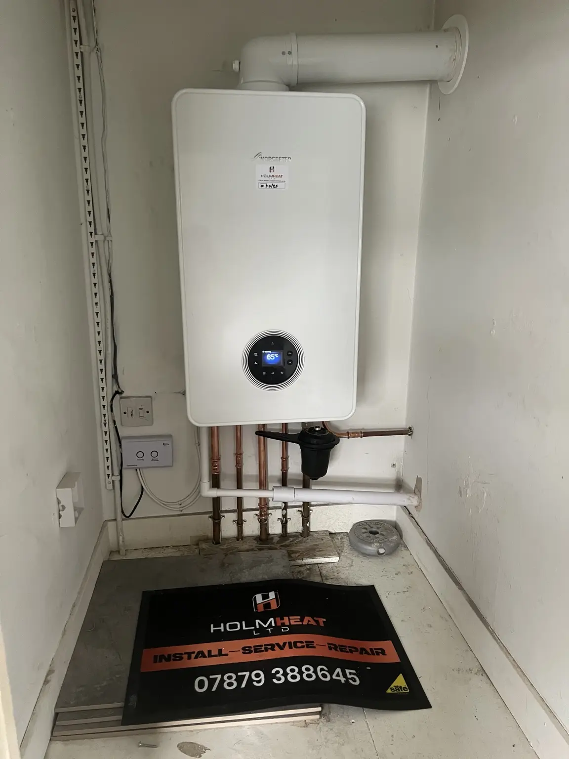 New combi boiler installed in a utility cupboard by HOLMHEAT