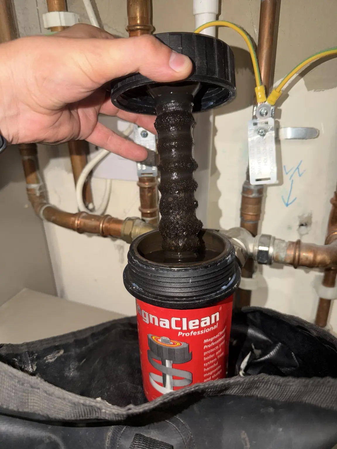 Magnetic boiler filter being cleaned